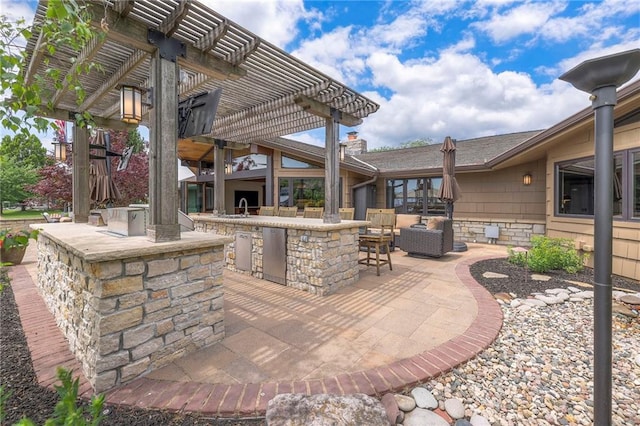 101 Algonquin Dr, Lake Winnebago, MO 64034 - view of patio / terrace with a pergola and an outdoor kitchen