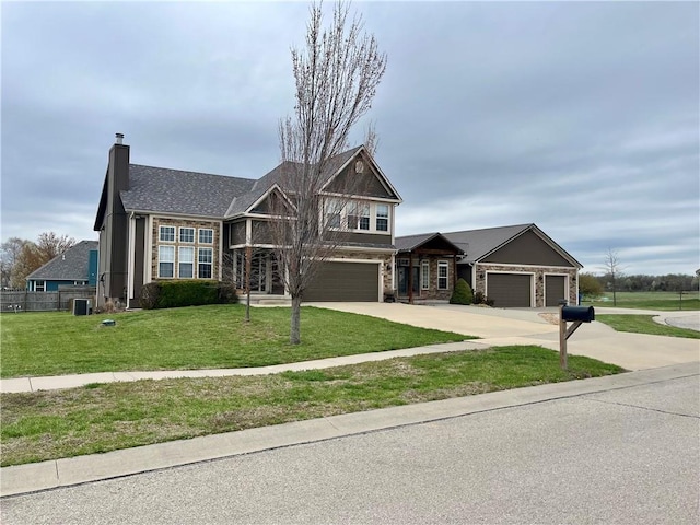 908 Cedar Ct, Paola, KS 66071 - view of front of house with a front yard, concrete driveway, a chimney, a garage, and cooling unit