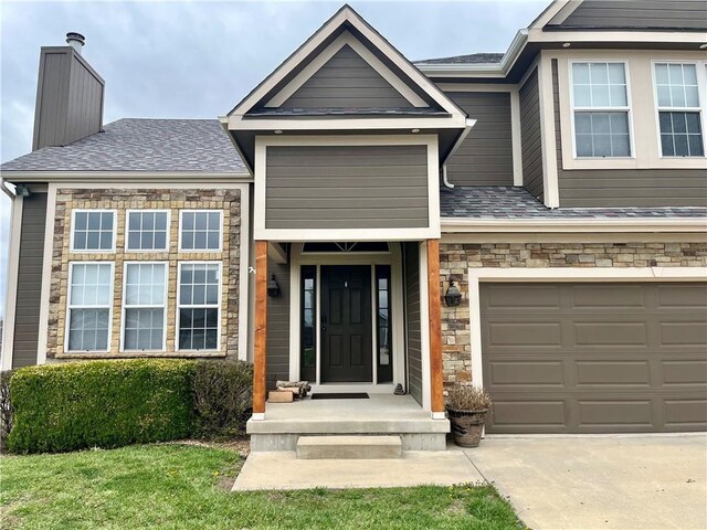 908 Cedar Ct, Paola, KS 66071 - view of front of property featuring stone siding, a chimney, driveway, a garage, and a shingled roof