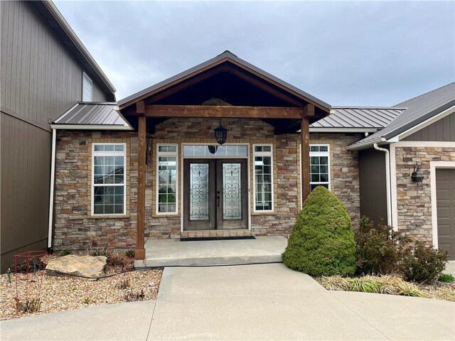 908 Cedar Ct, Paola, KS 66071 - doorway to property featuring stone siding, metal roof, and french doors