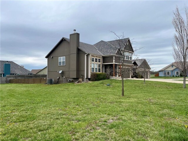908 Cedar Ct, Paola, KS 66071 - view of property exterior featuring a chimney, concrete driveway, and central AC