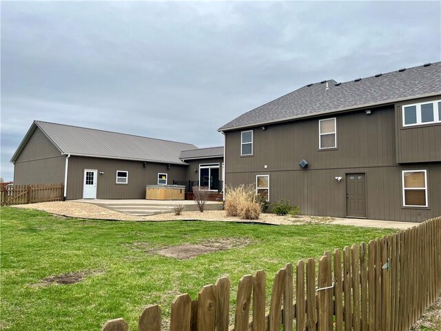 908 Cedar Ct, Paola, KS 66071 - rear view of house with a patio area and a hot tub