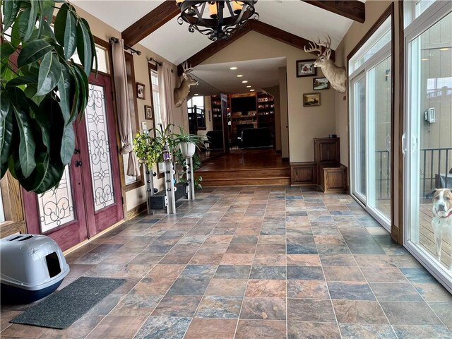 908 Cedar Ct, Paola, KS 66071 - foyer with stone finish floors, baseboards, and a chandelier