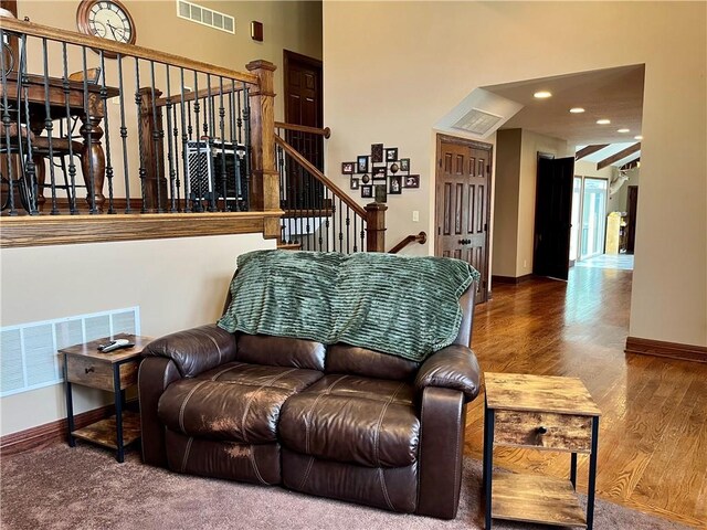 908 Cedar Ct, Paola, KS 66071 - living room featuring wood finished floors, baseboards, recessed lighting, stairs, and a towering ceiling