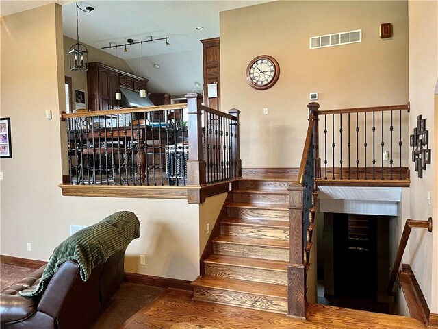908 Cedar Ct, Paola, KS 66071 - stairs featuring baseboards and wood finished floors
