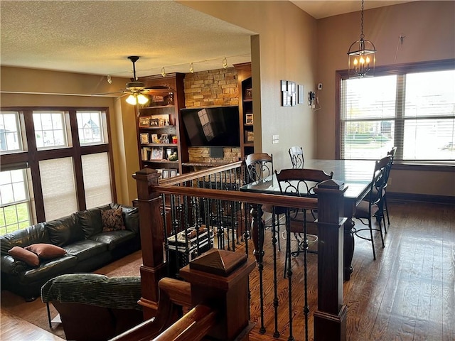 908 Cedar Ct, Paola, KS 66071 - dining area featuring rail lighting, a ceiling fan, healthy amount of natural light, hardwood / wood-style floors, and a textured ceiling