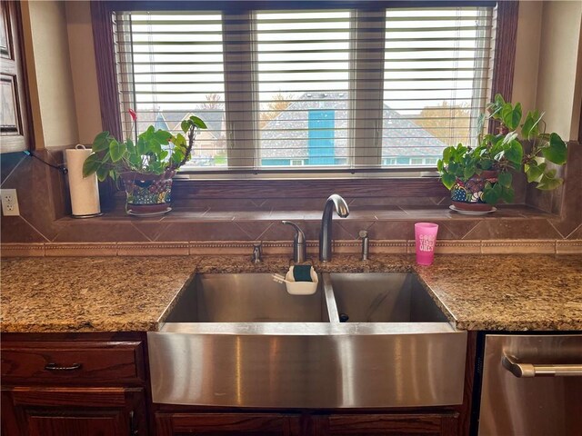 908 Cedar Ct, Paola, KS 66071 - kitchen view of a sink, backsplash, stainless steel dishwasher, and stone counters