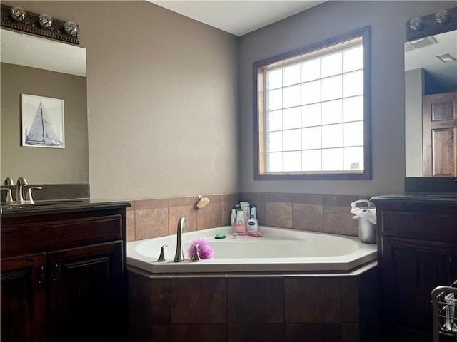 908 Cedar Ct, Paola, KS 66071 - bathroom featuring vanity and a garden tub