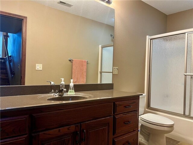 908 Cedar Ct, Paola, KS 66071 - full bathroom featuring combined bath / shower with glass door, vanity, and toilet