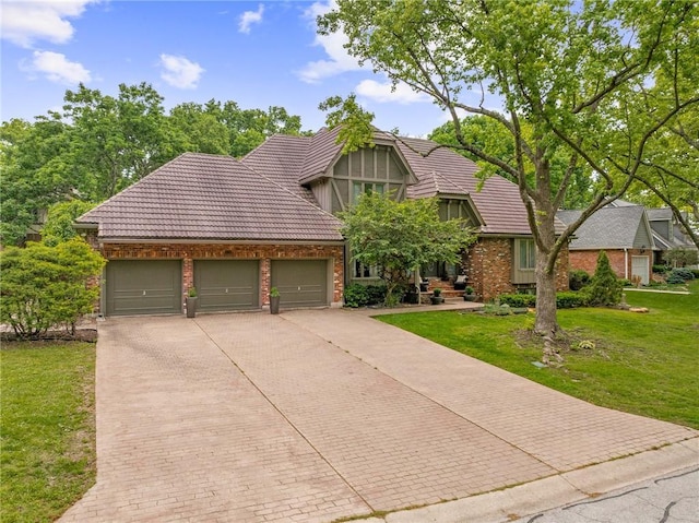 3705 W 119th Ter, Leawood, KS 66209 - english style home with concrete driveway, a garage, a front lawn, and a tile roof
