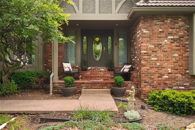 3705 W 119th Ter, Leawood, KS 66209 - doorway to property featuring covered porch and brick siding