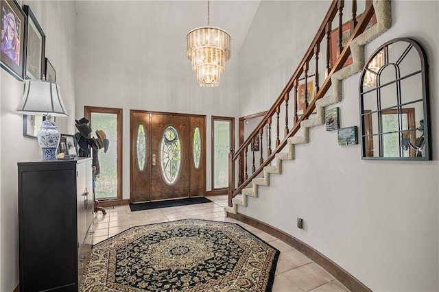 3705 W 119th Ter, Leawood, KS 66209 - tiled entryway with a high ceiling, a chandelier, baseboards, and stairs