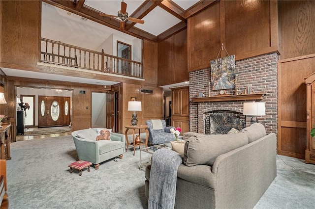 3705 W 119th Ter, Leawood, KS 66209 - carpeted living area with a high ceiling, a ceiling fan, wood walls, a fireplace, and coffered ceiling