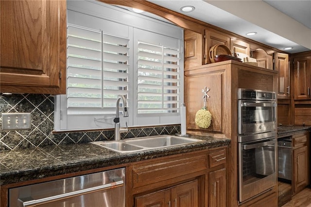 3705 W 119th Ter, Leawood, KS 66209 - kitchen featuring stainless steel appliances, a sink, backsplash, brown cabinets, and recessed lighting