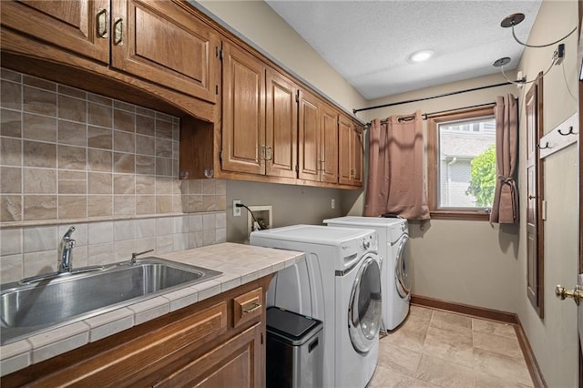 3705 W 119th Ter, Leawood, KS 66209 - washroom with washer and clothes dryer, cabinet space, baseboards, and a textured ceiling