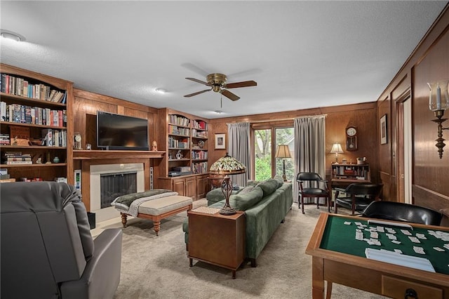 3705 W 119th Ter, Leawood, KS 66209 - living area with ceiling fan, light colored carpet, wooden walls, and a fireplace