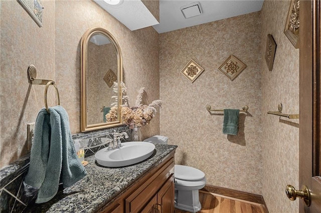 3705 W 119th Ter, Leawood, KS 66209 - bathroom with wood finished floors, toilet, vanity, and backsplash
