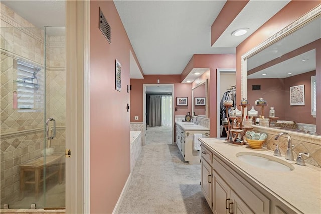 3705 W 119th Ter, Leawood, KS 66209 - bathroom featuring a stall shower, two vanities, a garden tub, and recessed lighting