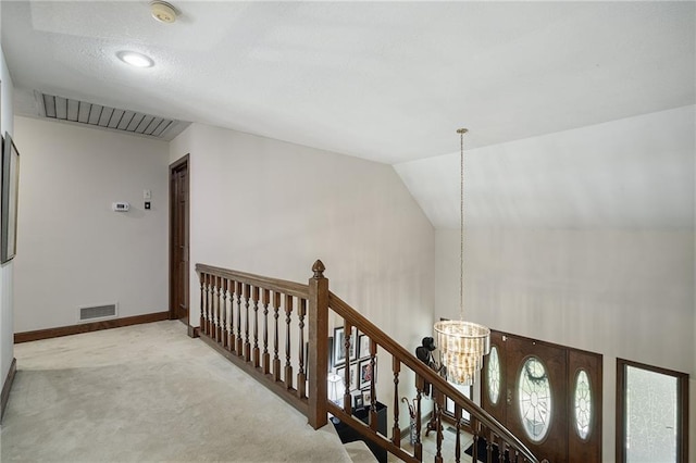3705 W 119th Ter, Leawood, KS 66209 - hallway with a chandelier, an upstairs landing, carpet, baseboards, and vaulted ceiling