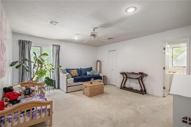 3705 W 119th Ter, Leawood, KS 66209 - living area with light colored carpet, ceiling fan, and a textured ceiling