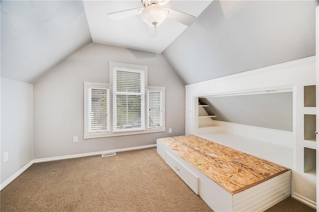 unfurnished bedroom with visible vents, carpet floors, a ceiling fan, baseboards, and vaulted ceiling