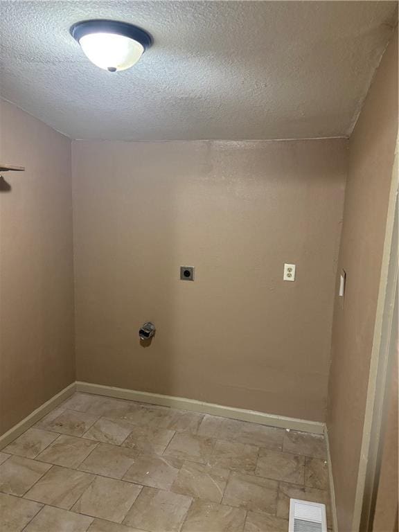 6941 Spruce Ave, Kansas City, MO 64132 - washroom with hookup for an electric dryer and a textured ceiling