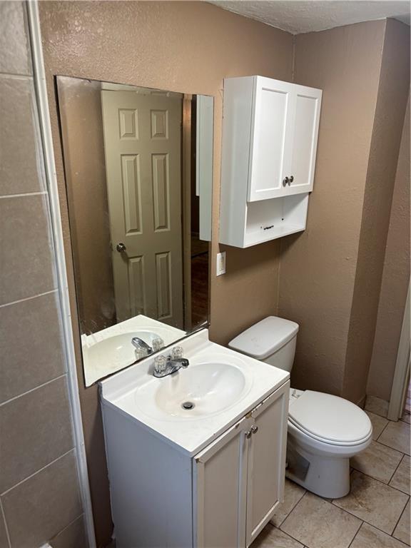 6941 Spruce Ave, Kansas City, MO 64132 - half bath featuring vanity and tile patterned flooring