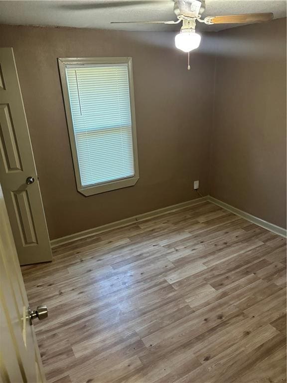 6941 Spruce Ave, Kansas City, MO 64132 - unfurnished room featuring ceiling fan and wood finished floors