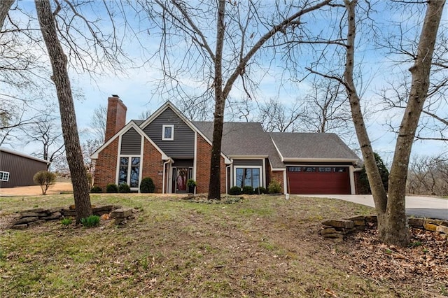 15411 Evans Rd, Basehor, KS 66007 - traditional home featuring concrete driveway, an attached garage, a chimney, and brick siding