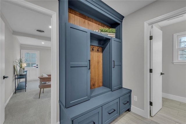 mudroom featuring light carpet, baseboards, and visible vents