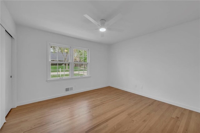 unfurnished bedroom featuring baseboards, visible vents, a closet, and light wood-type flooring