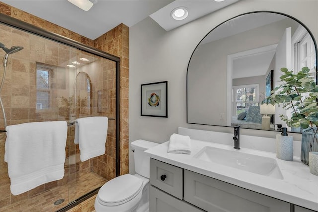 full bath with a shower stall, toilet, recessed lighting, vanity, and ensuite bath