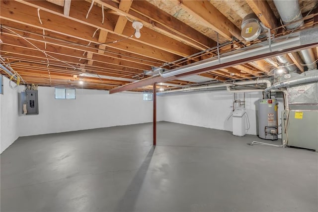 basement with heating unit, water heater, and electric panel