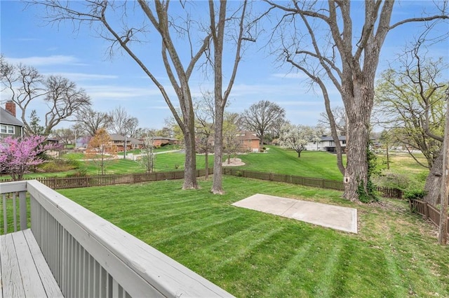 view of yard with a fenced backyard, a residential view, a patio area, and a deck