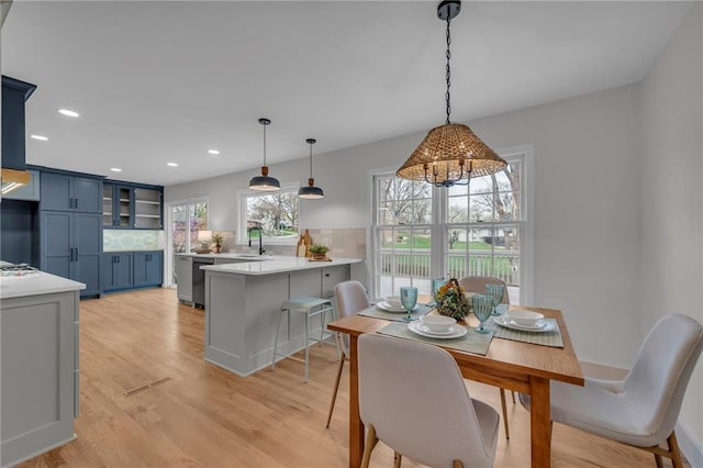 dining room with light wood-style floors and recessed lighting
