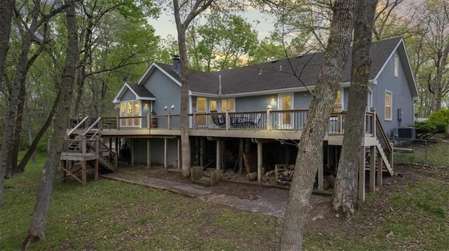back of house with roof with shingles, cooling unit, stairs, and a wooden deck