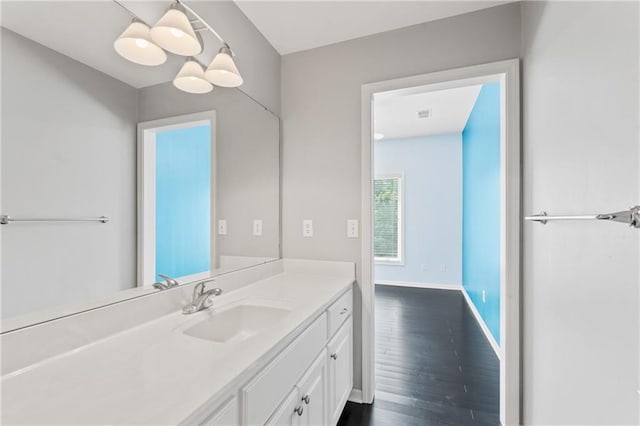 11273 S Lakecrest Dr, Olathe, KS 66061 - bathroom featuring wood finished floors, vanity, and baseboards