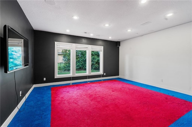 11273 S Lakecrest Dr, Olathe, KS 66061 - carpeted empty room featuring a textured ceiling, plenty of natural light, baseboards, and recessed lighting