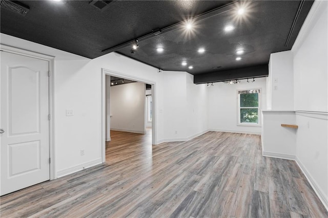 11273 S Lakecrest Dr, Olathe, KS 66061 - below grade area featuring wood finished floors, track lighting, baseboards, and recessed lighting