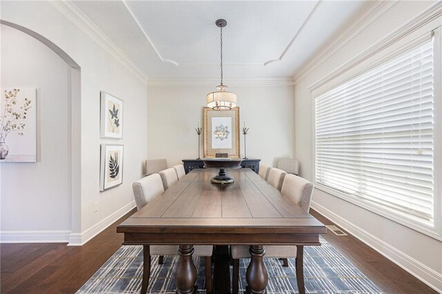 dining room featuring arched walkways, dark wood-style flooring, visible vents, and baseboards