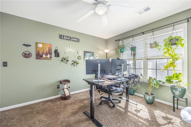 carpeted office with ceiling fan, baseboards, and visible vents