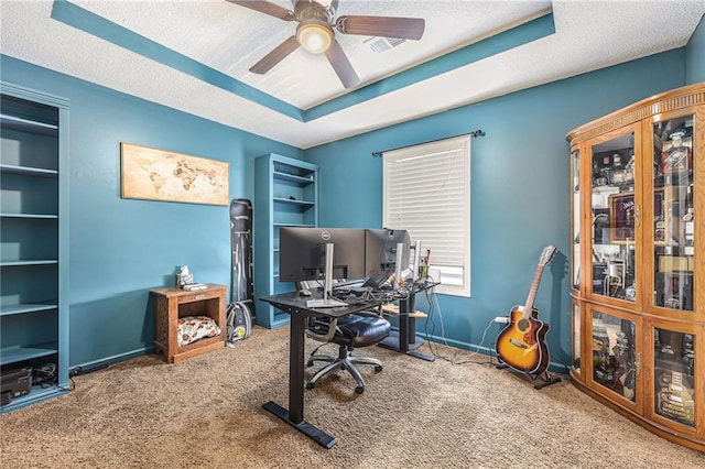office featuring a ceiling fan, a textured ceiling, visible vents, and carpet