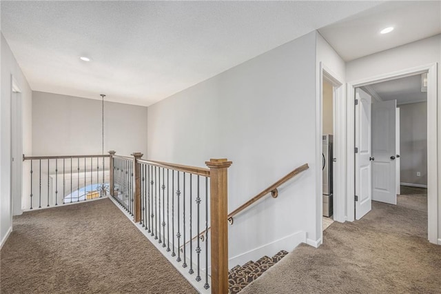 hallway with recessed lighting, carpet floors, baseboards, and an upstairs landing