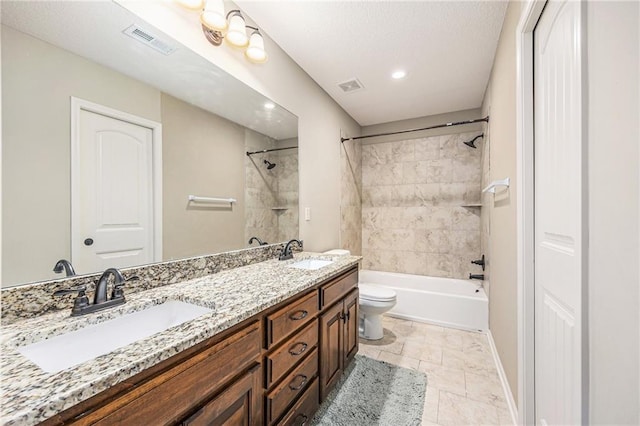 full bathroom with visible vents, toilet, and a sink