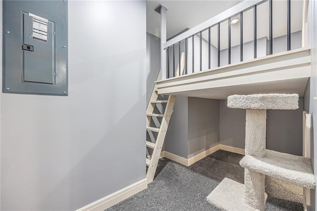 staircase with electric panel, carpet flooring, and baseboards