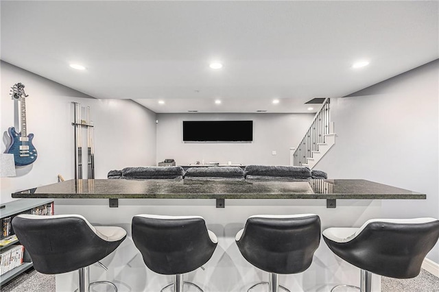 bar featuring stairway and recessed lighting