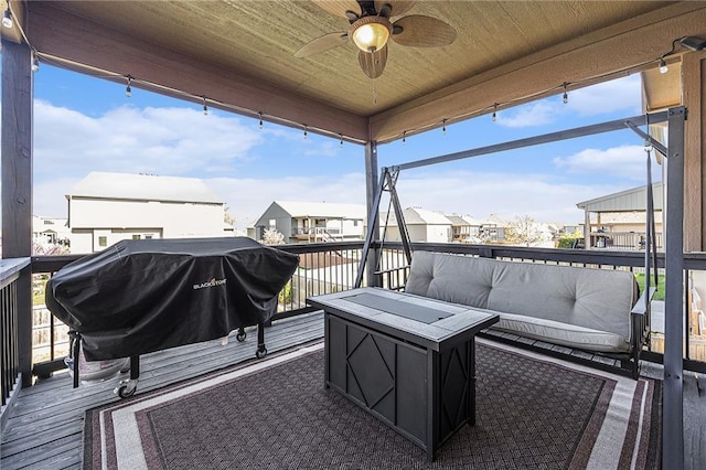 wooden deck with an outdoor living space with a fire pit, a residential view, a ceiling fan, and area for grilling