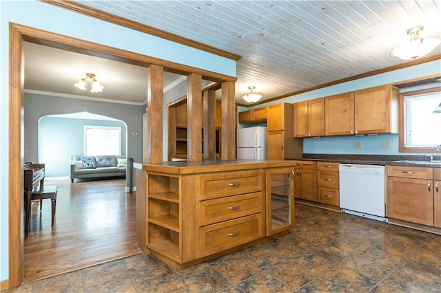 1306 W 29th St S, Independence, MO 64052 - kitchen with white appliances, crown molding, arched walkways, brown cabinets, and dark countertops