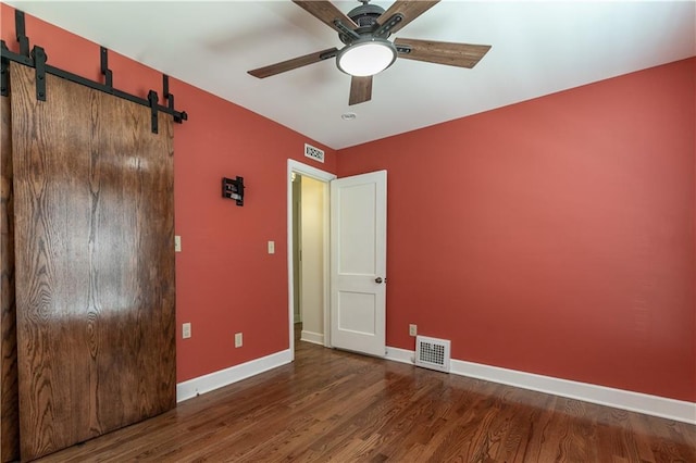 1306 W 29th St S, Independence, MO 64052 - empty room with a ceiling fan, wood finished floors, and a barn door