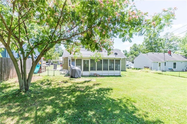 1306 W 29th St S, Independence, MO 64052 - rear view of property featuring a sunroom and a fenced backyard